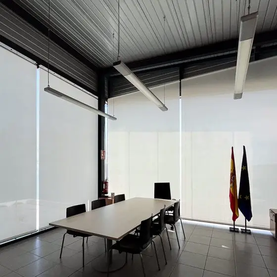 Sala de juntas con estores manuales Bandalux a medida. Mesa de juntas, sillón de dirección y sillas